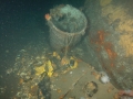 Water tight deck cannister with remains of a rubber life raft