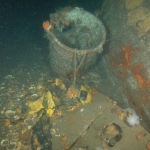Water tight deck cannister with remains of a rubber life raft
